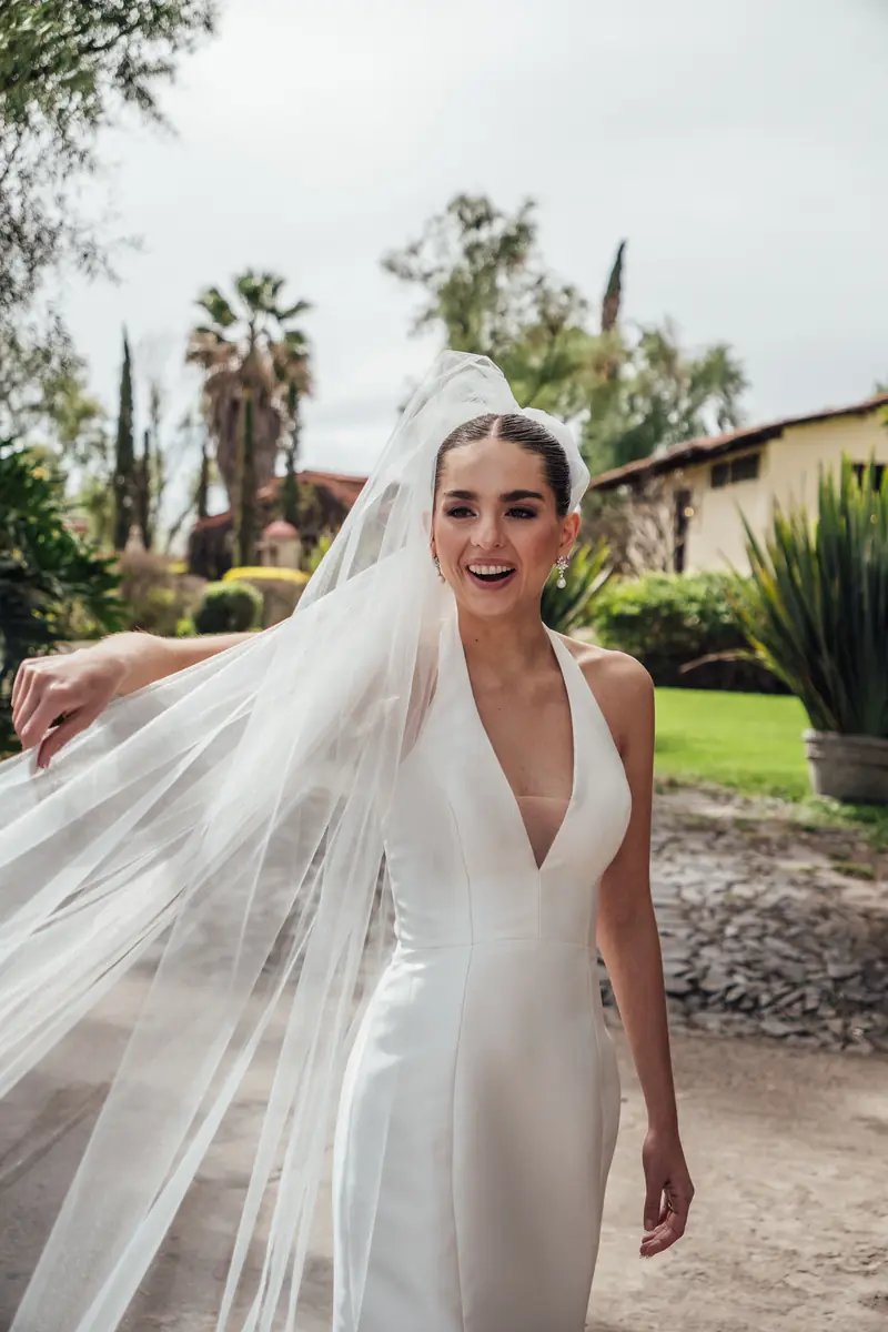 Bride with her veil in the air in the garden at Hacienda La Magdalena
