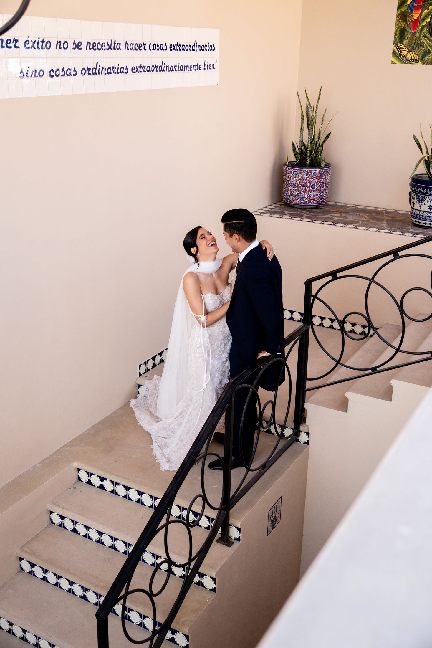 Couple laughing on a Talavera-tiled staircase, Jalisco wedding venue
