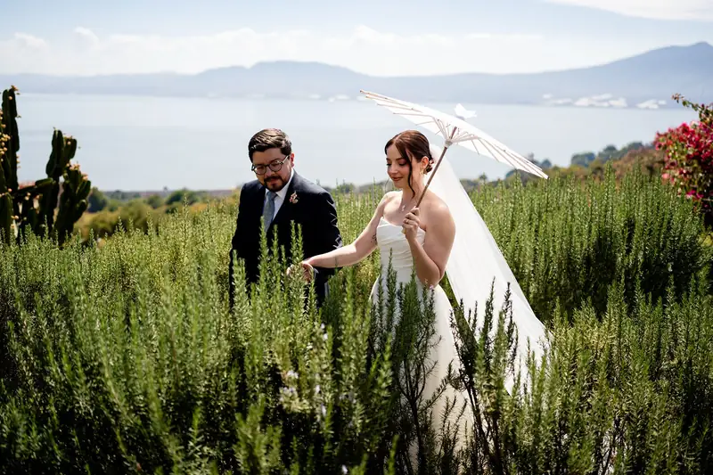 Couple under a parasol in a rosemary field above Lake Chapala, at Chapinaya, Ajijic